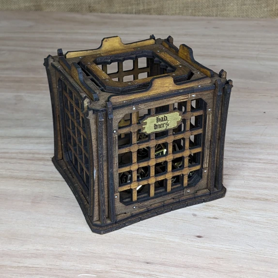 Engraved wooden dice jail with barred sides, designed to imprison naughty dice during tabletop games
