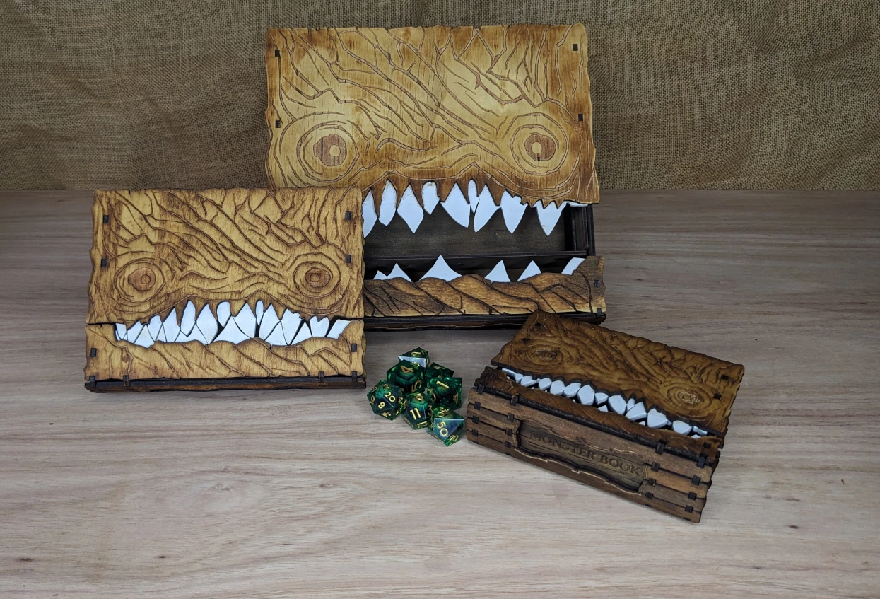 Set of three wooden monster book storage boxes in small, medium, and large sizes (A7, A6, A5), engraved fantasy book boxes with internal compartments, medium size fits two card decks